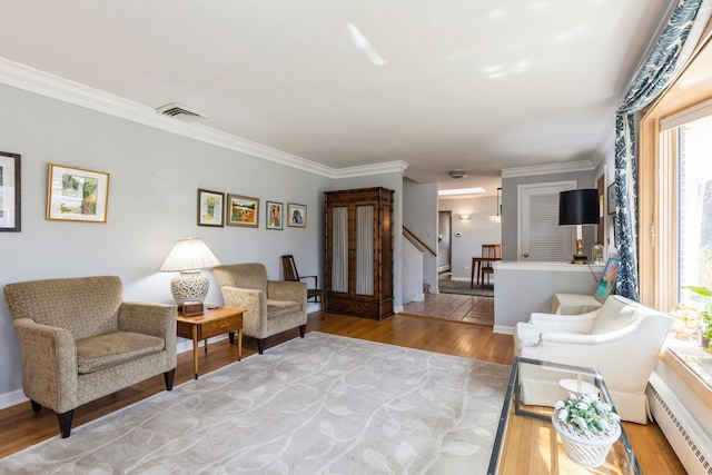 3528 Forest Ave, Wilmette, IL 60091 - living room featuring a baseboard heating unit, light wood-style flooring, visible vents, and ornamental molding