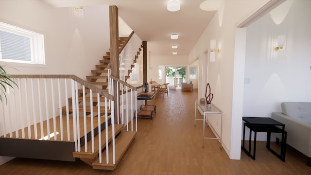 hall featuring light wood finished floors and stairs