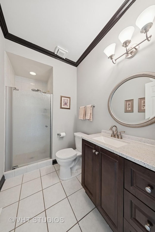 bathroom with tile patterned flooring, crown molding, vanity, toilet, and a shower stall