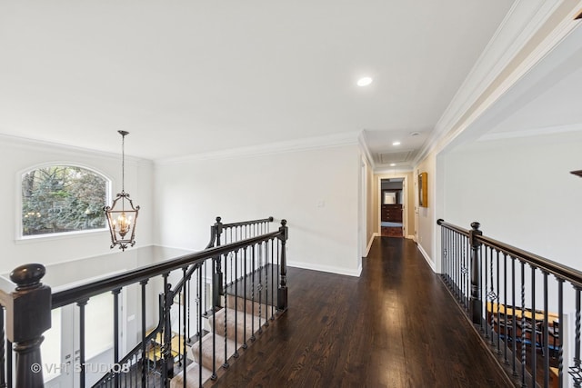 hallway featuring attic access, recessed lighting, an upstairs landing, wood finished floors, and ornamental molding