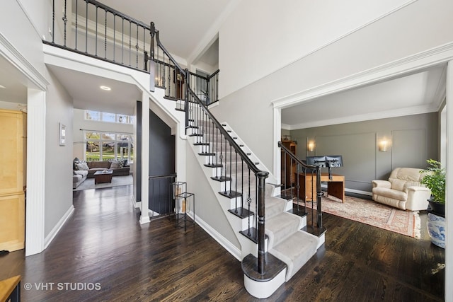 entrance foyer with baseboards, stairs, and wood finished floors