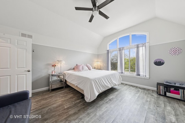 bedroom with baseboards, vaulted ceiling, wood finished floors, and visible vents