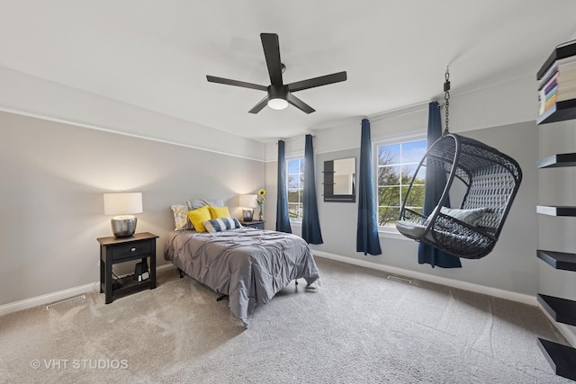carpeted bedroom featuring a ceiling fan, baseboards, and visible vents