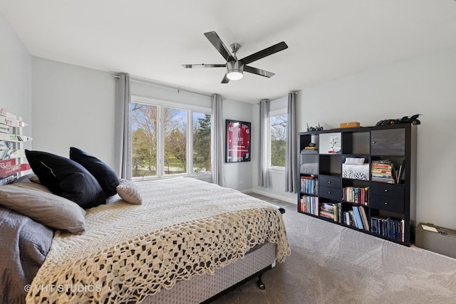 carpeted bedroom with baseboards and a ceiling fan
