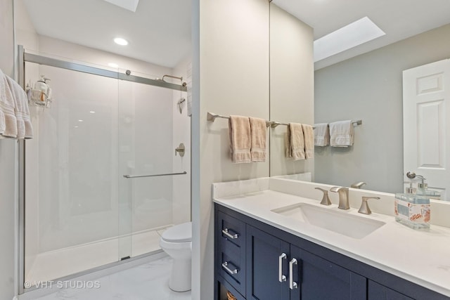 full bathroom with vanity, marble finish floor, a stall shower, and toilet