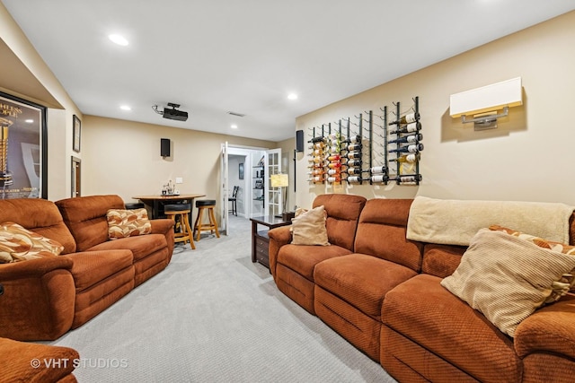 living room featuring recessed lighting, visible vents, and light carpet