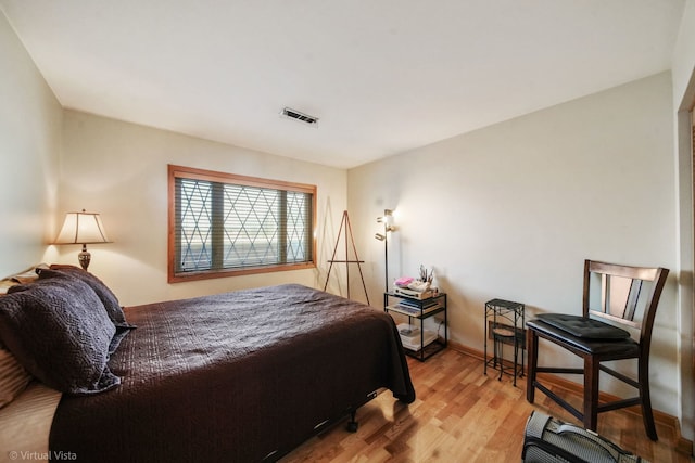 bedroom with wood finished floors and visible vents