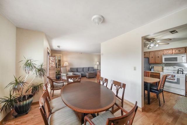 dining room with ceiling fan, visible vents, and light wood-style flooring