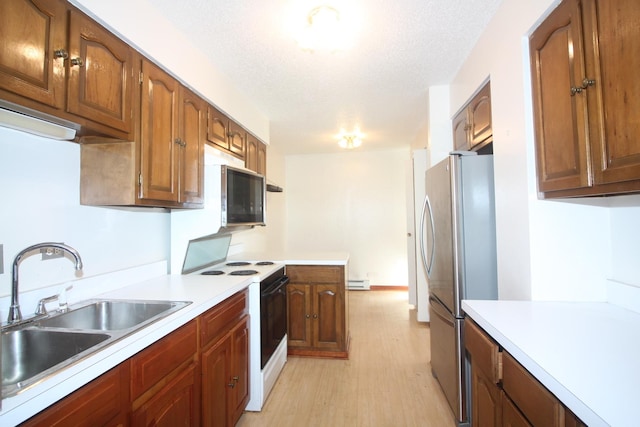 5471 S Hyde Park Blvd Unit 10A, Chicago, IL 60615 - kitchen with a sink, light countertops, light wood-type flooring, baseboard heating, and stainless steel appliances