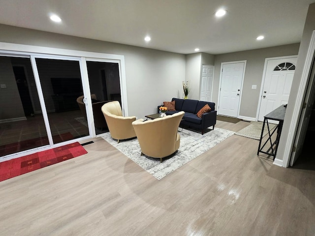 living area featuring wood finished floors, baseboards, and recessed lighting