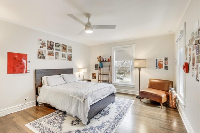 bedroom with baseboards, a ceiling fan, and wood finished floors