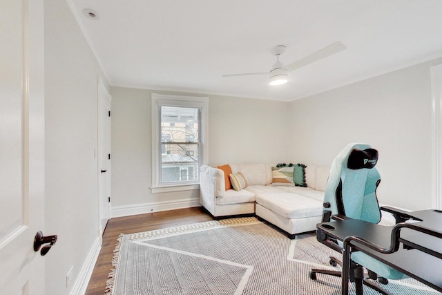 home office with wood finished floors, ceiling fan, and baseboards