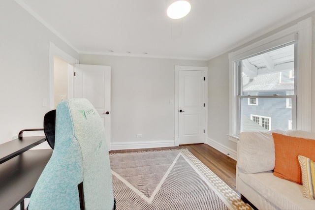 office space featuring crown molding, wood finished floors, and baseboards