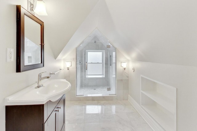 bathroom with a shower stall, marble finish floor, vanity, and vaulted ceiling