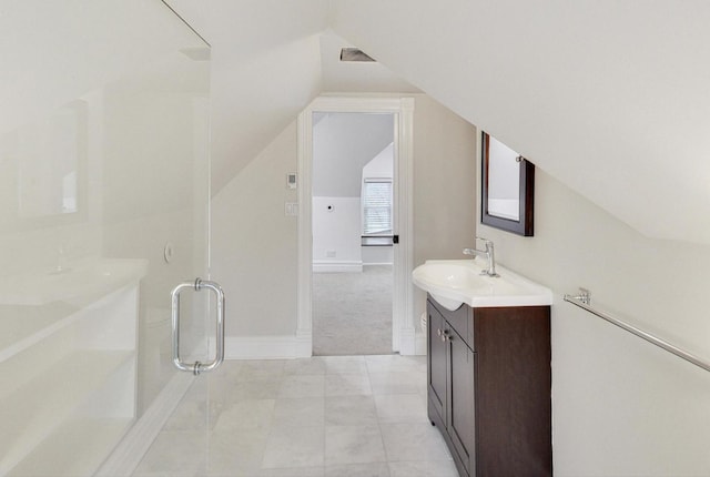 bathroom featuring vanity, baseboards, a stall shower, and lofted ceiling