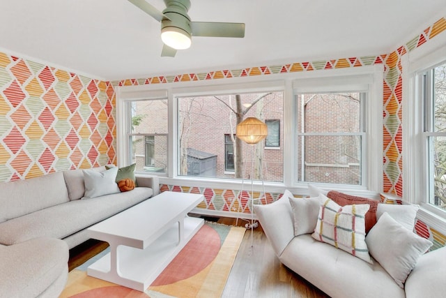 living room featuring a ceiling fan and wood finished floors