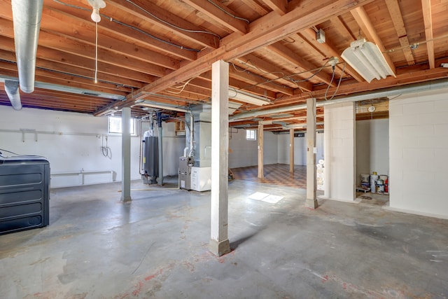 basement featuring water heater and heating unit