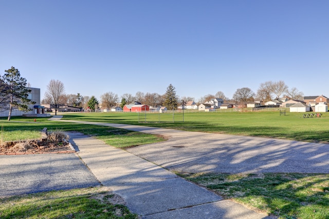 surrounding community featuring a yard and a residential view
