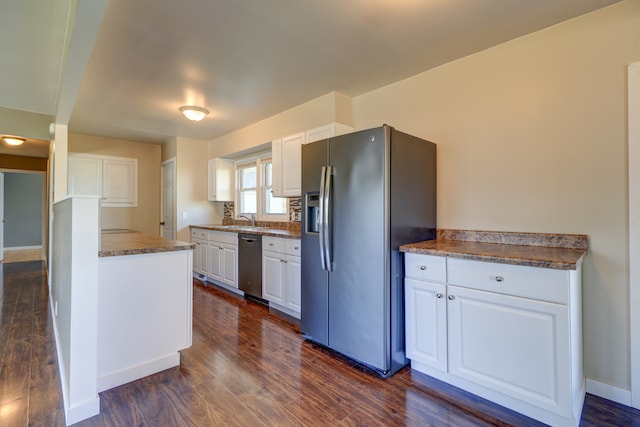 kitchen featuring white cabinets, stainless steel appliances, and a sink