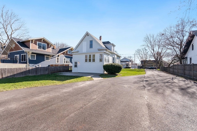 280 Westerfield Pl, Grayslake, IL 60030 - exterior space with a front lawn, fence, a residential view, and driveway