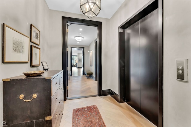 interior space with elevator and baseboards
