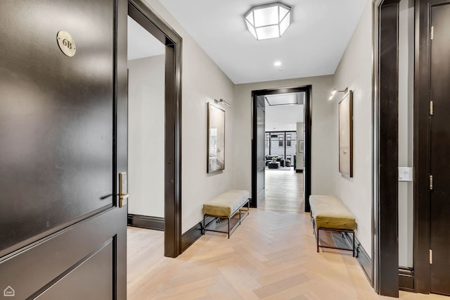 corridor featuring baseboards and recessed lighting