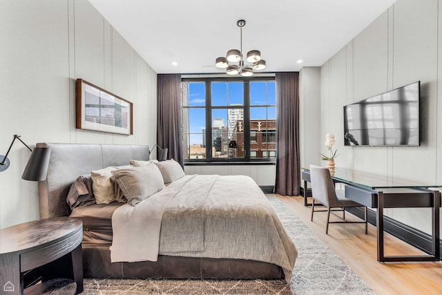 bedroom with recessed lighting, light wood-type flooring, and a chandelier