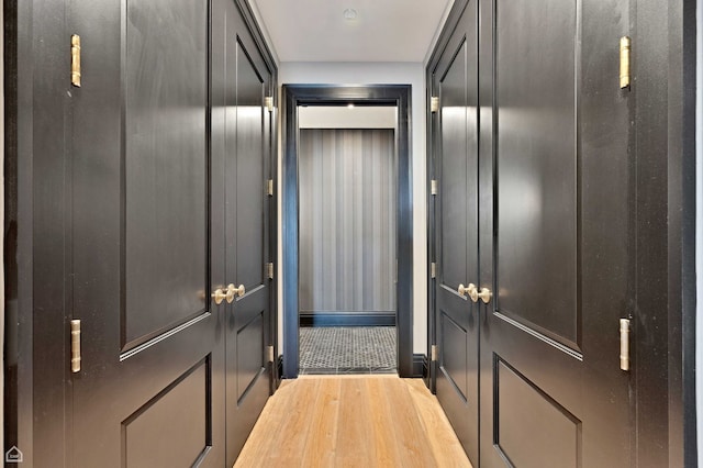 interior space featuring baseboards and wood finished floors