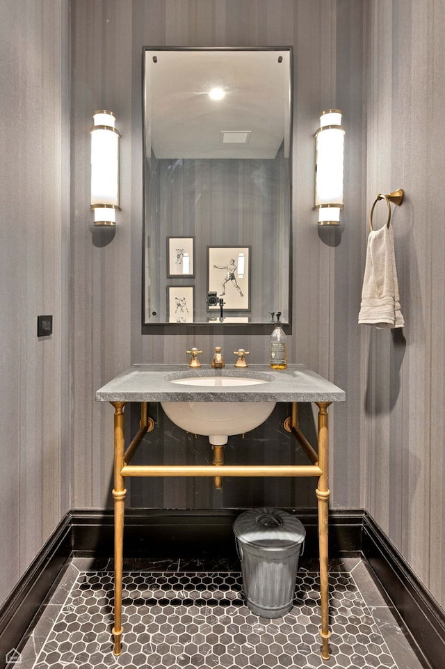 bathroom with baseboards and tile patterned floors