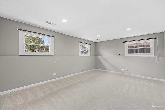 empty room with baseboards, carpet flooring, recessed lighting, and visible vents