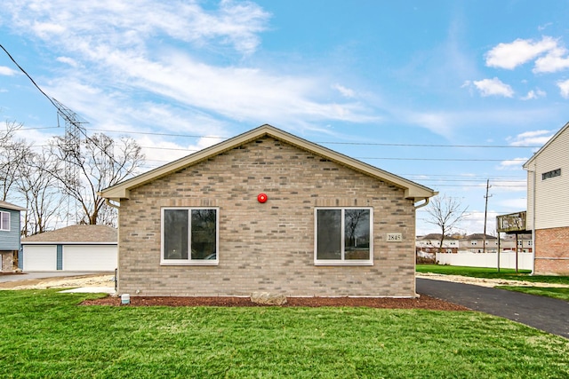 1409 172nd St, Hazel Crest, IL 60429 - view of side of property featuring a garage, brick siding, an outdoor structure, and a lawn
