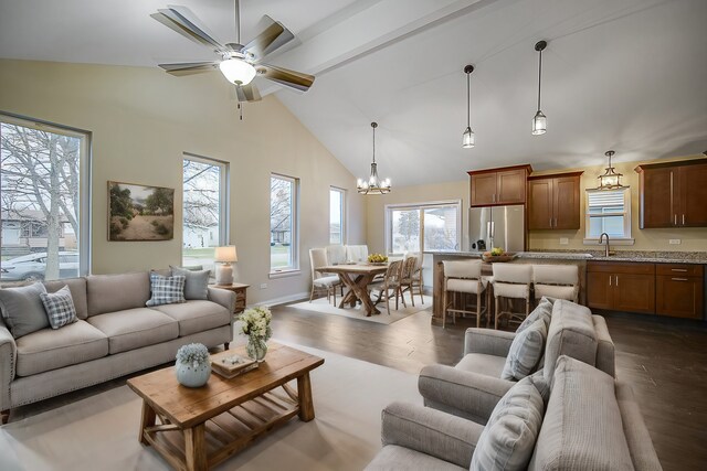 1409 172nd St, Hazel Crest, IL 60429 - living area with high vaulted ceiling, dark wood-type flooring, ceiling fan with notable chandelier, and a healthy amount of sunlight