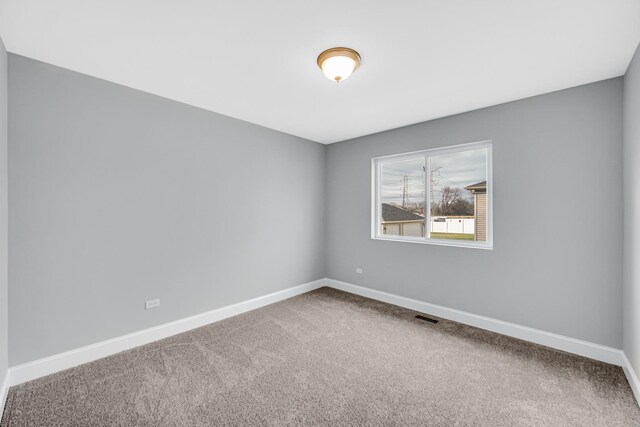 1409 172nd St, Hazel Crest, IL 60429 - carpeted spare room with visible vents and baseboards