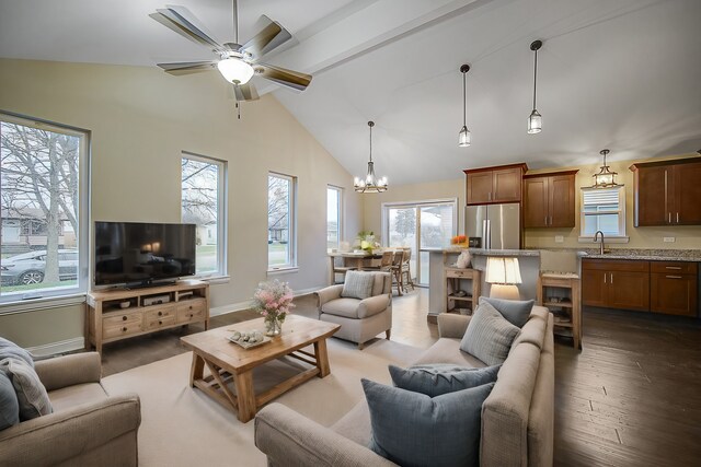 1409 172nd St, Hazel Crest, IL 60429 - living room with ceiling fan with notable chandelier, high vaulted ceiling, dark wood finished floors, and plenty of natural light