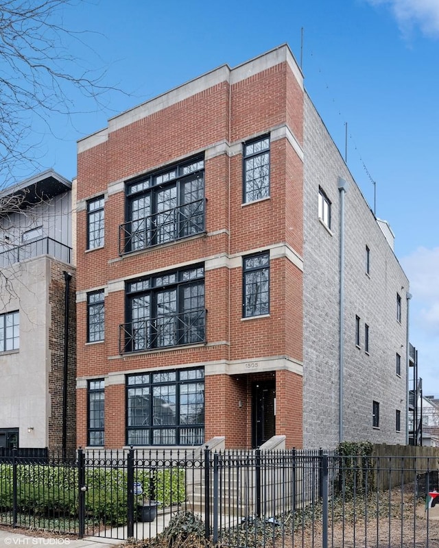 view of building exterior featuring a fenced front yard