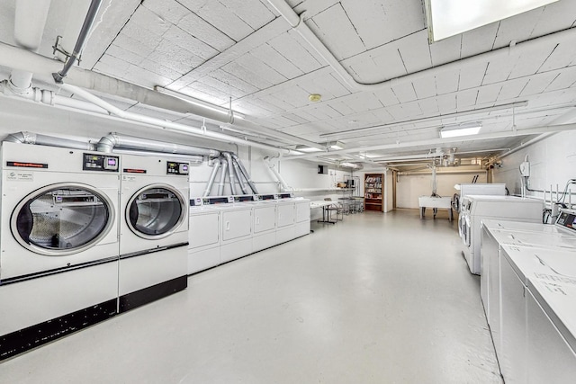 community laundry room featuring a sink and washing machine and clothes dryer