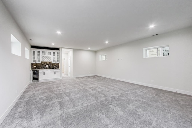 3242 N Kostner Ave, Chicago, IL 60641 - below grade area with baseboards, recessed lighting, beverage cooler, light colored carpet, and bar