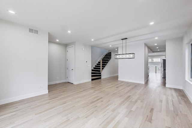 3242 N Kostner Ave, Chicago, IL 60641 - unfurnished living room featuring visible vents, baseboards, light wood-style floors, recessed lighting, and stairs