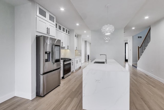 3242 N Kostner Ave, Chicago, IL 60641 - kitchen with recessed lighting, white cabinetry, visible vents, stainless steel appliances, and a sink