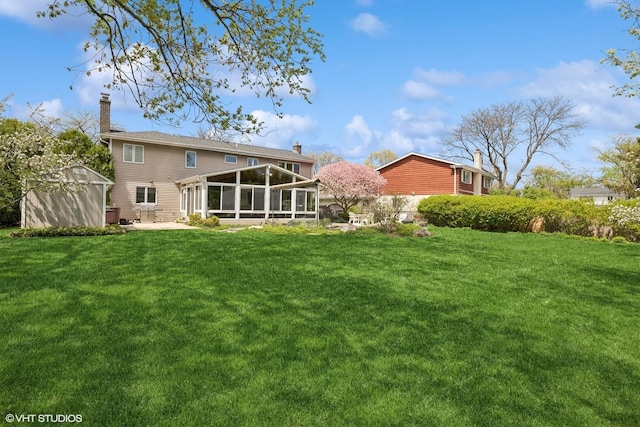 1831 Ellendale Dr, Northbrook, IL 60062 - back of property featuring a sunroom, a shed, a lawn, an outdoor structure, and a patio area