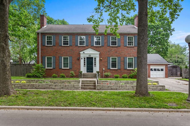 716 W Iowa St, Urbana, IL 61801 - colonial-style house with a chimney, driveway, and brick siding