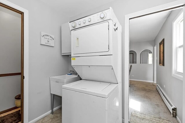 10922 Massasoit Ave, Chicago Ridge, IL 60415 - clothes washing area featuring a baseboard radiator, stacked washer and dryer, laundry area, and baseboards