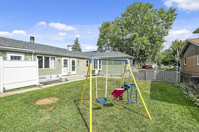 10922 Massasoit Ave, Chicago Ridge, IL 60415 - back of house featuring entry steps, a yard, a fenced backyard, and a playground
