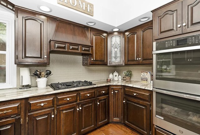 10922 Massasoit Ave, Chicago Ridge, IL 60415 - kitchen with custom range hood, decorative backsplash, double oven, and gas cooktop