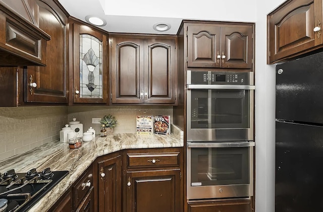 10922 Massasoit Ave, Chicago Ridge, IL 60415 - kitchen featuring dark brown cabinets, decorative backsplash, black appliances, and light stone countertops