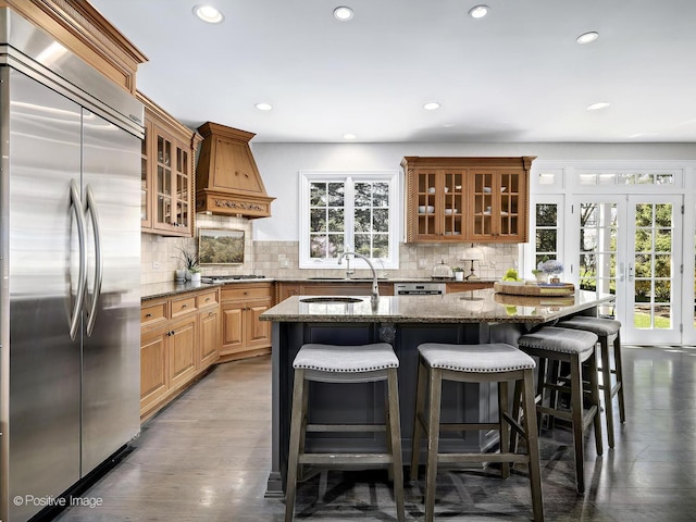 116 Springlake Ave, Hinsdale, IL 60521 - kitchen with dark stone counters, a breakfast bar area, stainless steel appliances, custom range hood, and recessed lighting