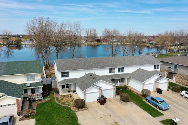 birds eye view of property with a water view and a residential view