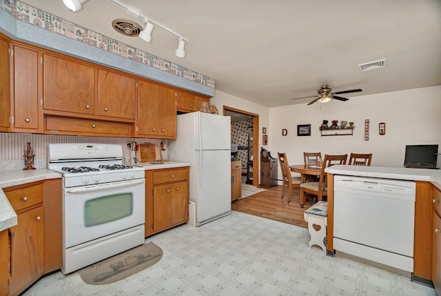 102 Robinson Dr, Morris, IL 60450 - kitchen featuring white appliances, a ceiling fan, brown cabinetry, light countertops, and light flooring