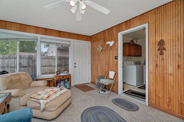 102 Robinson Dr, Morris, IL 60450 - living room featuring wooden walls, a ceiling fan, carpet floors, baseboards, and washing machine and clothes dryer