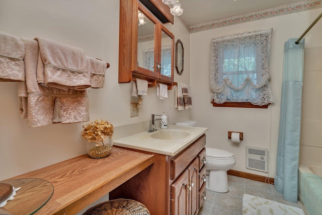 102 Robinson Dr, Morris, IL 60450 - bathroom featuring heating unit, toilet, vanity, tile patterned floors, and baseboards